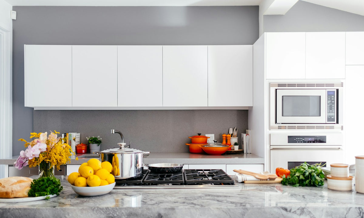 Modern white kitchen with a marble island